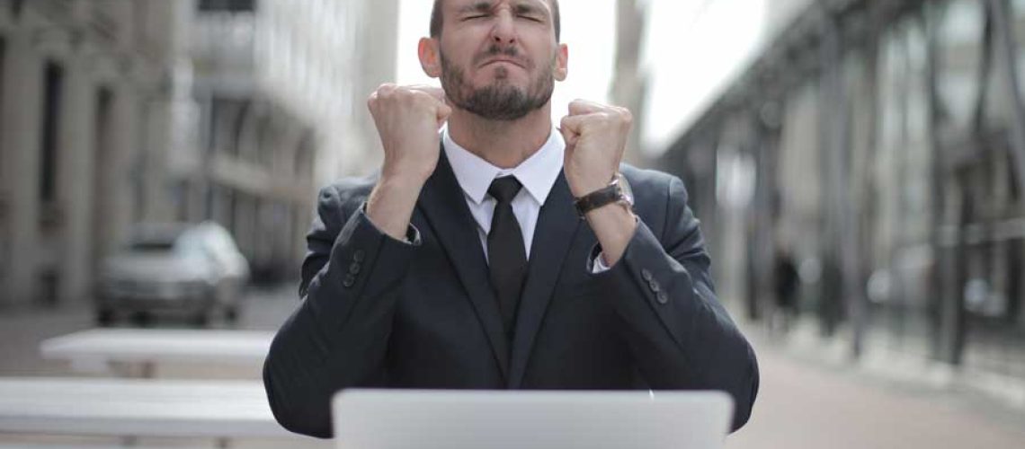 man-in-black-suit-sitting-on-chair-beside-buildings-3778966